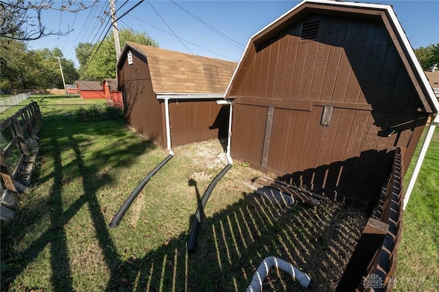 view of outbuilding featuring a lawn