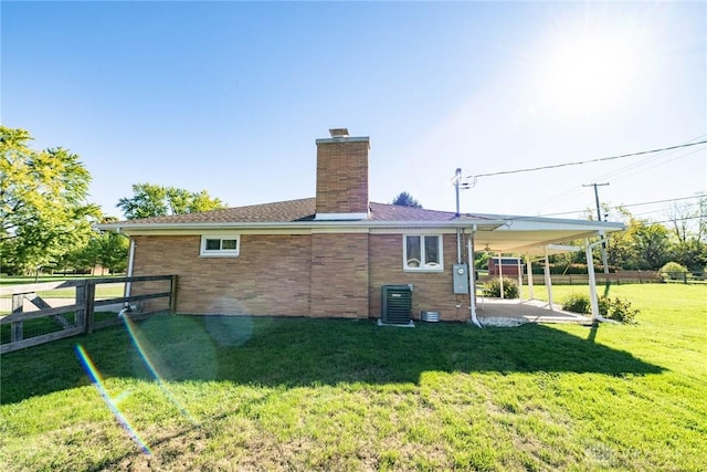 back of property featuring cooling unit, a patio area, and a yard