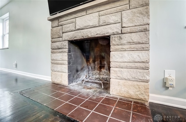 room details featuring hardwood / wood-style floors and a stone fireplace