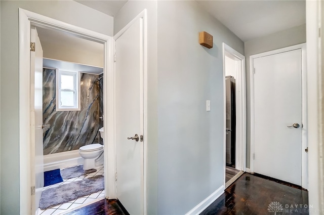 corridor with dark hardwood / wood-style flooring