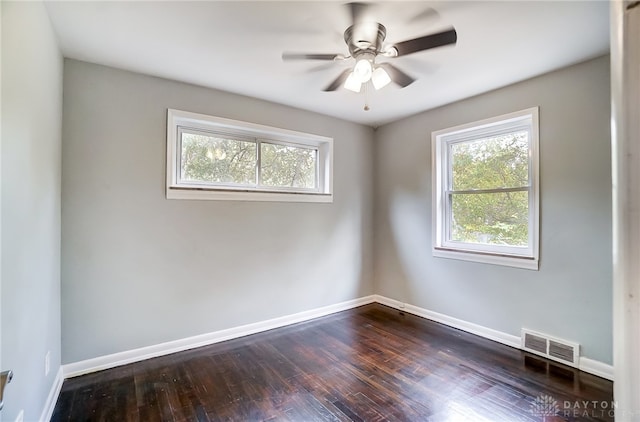 spare room featuring ceiling fan and dark wood-type flooring