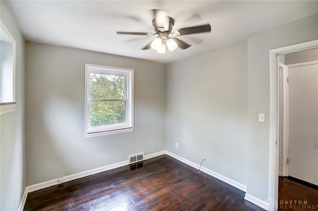 unfurnished room featuring ceiling fan and dark wood-type flooring