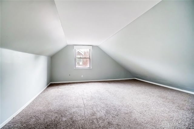 bonus room with carpet floors and lofted ceiling