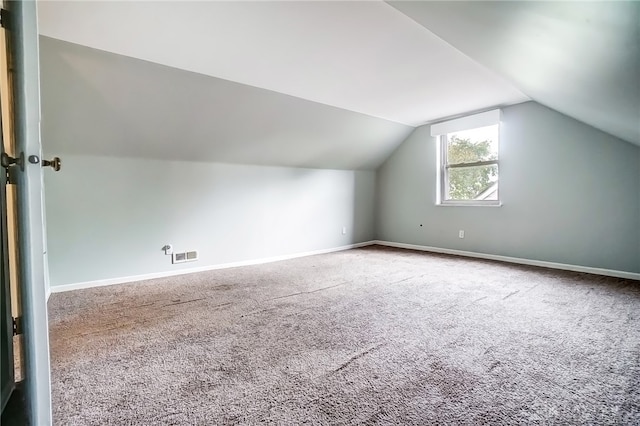 bonus room featuring vaulted ceiling and carpet flooring