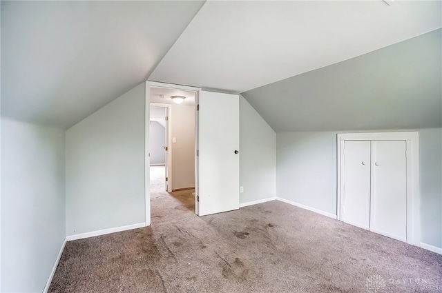 additional living space with lofted ceiling and light colored carpet