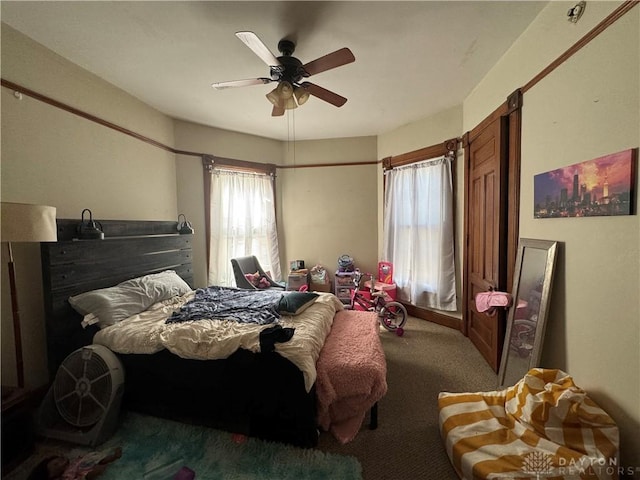 bedroom with ceiling fan and carpet