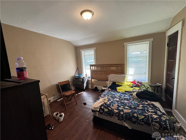 bedroom with lofted ceiling and dark hardwood / wood-style flooring