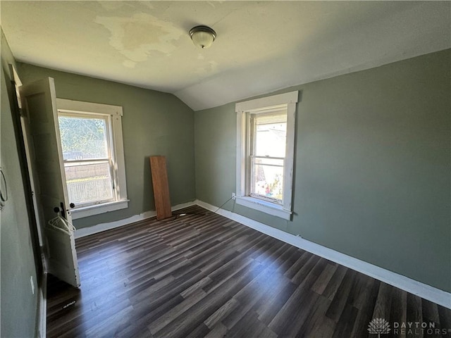 bonus room with lofted ceiling and dark wood-type flooring