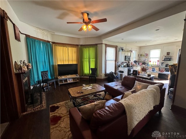 living room with ceiling fan and dark hardwood / wood-style floors