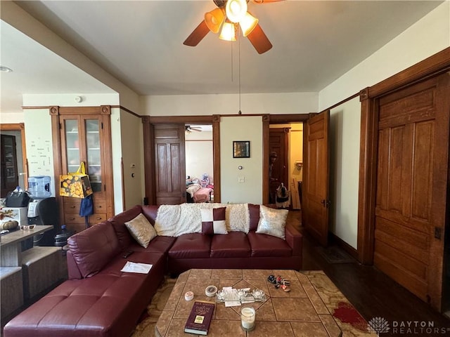 living room with dark hardwood / wood-style flooring and ceiling fan