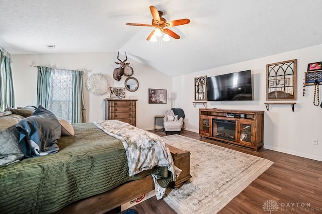 bedroom featuring ceiling fan, dark hardwood / wood-style floors, and vaulted ceiling