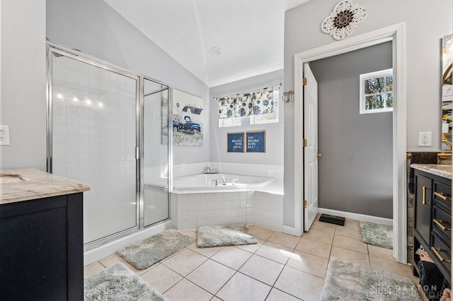 bathroom featuring vanity, lofted ceiling, shower with separate bathtub, and tile patterned flooring