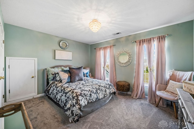 bedroom featuring multiple windows and carpet