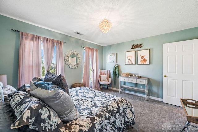 carpeted bedroom featuring a textured ceiling