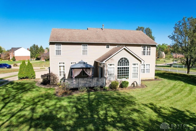 back of house with a yard and a wooden deck