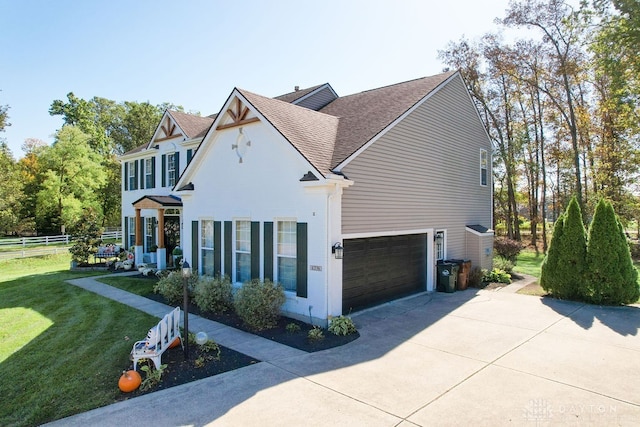 view of front of home featuring a front yard and a garage