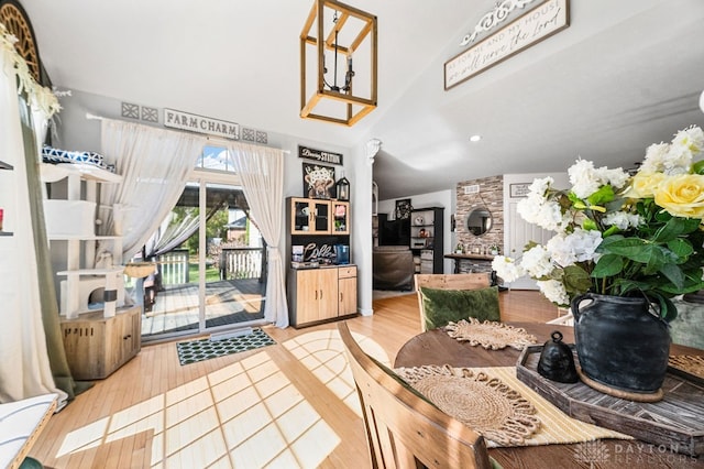 dining room with vaulted ceiling and hardwood / wood-style flooring