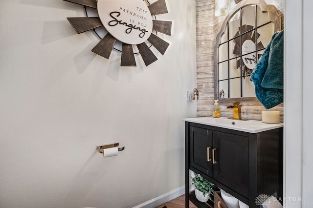 bathroom with tasteful backsplash, hardwood / wood-style floors, and vanity