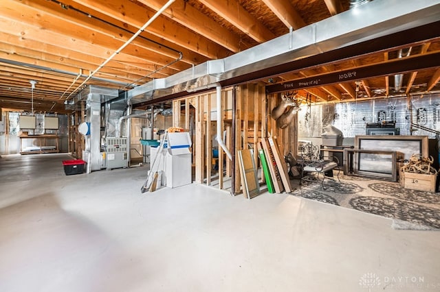 basement with a healthy amount of sunlight and heating unit