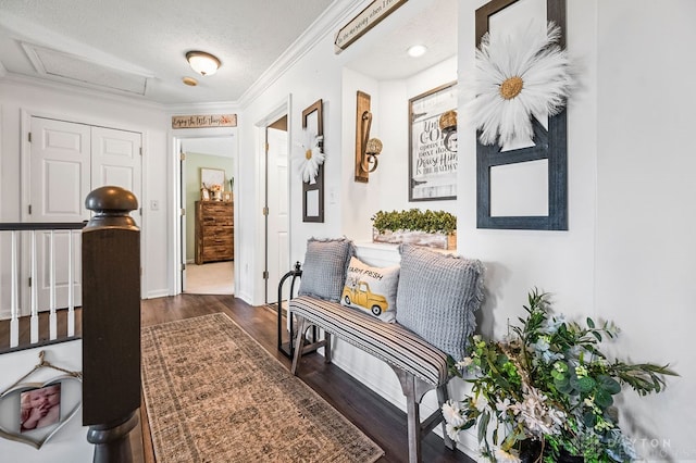 corridor featuring ornamental molding, a textured ceiling, and dark hardwood / wood-style flooring