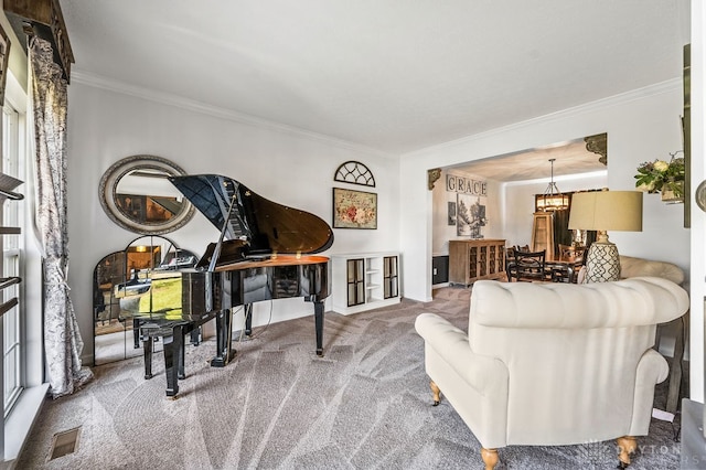 carpeted living room with ornamental molding and a notable chandelier