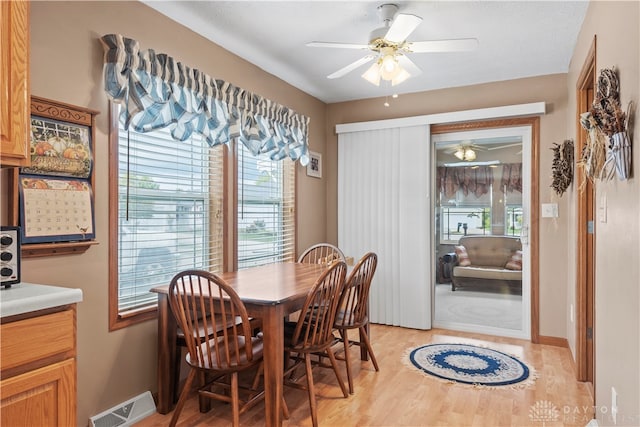 dining area with ceiling fan and light hardwood / wood-style floors