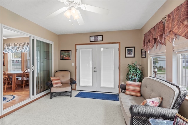 sitting room featuring french doors, carpet floors, ceiling fan, and a wealth of natural light