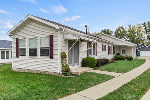 view of front of home with a front lawn and a garage