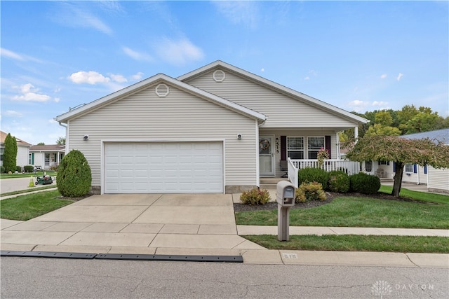 view of front of home featuring a garage, a porch, and a front lawn