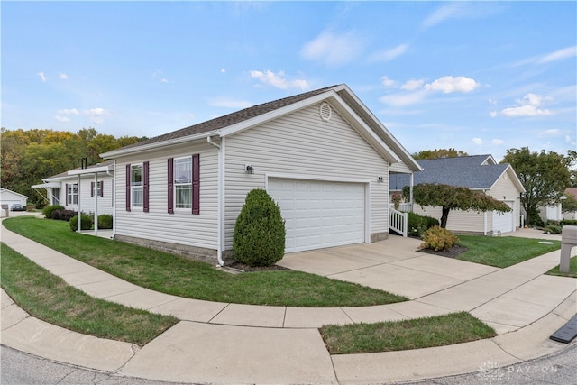 view of home's exterior featuring a lawn and a garage