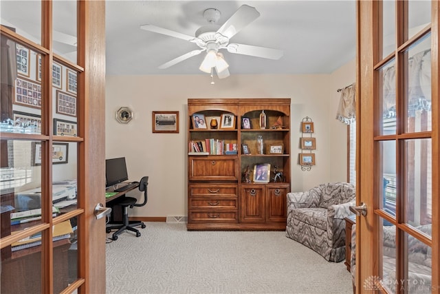 carpeted office featuring ceiling fan and a wealth of natural light