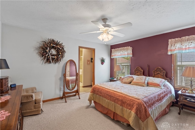 carpeted bedroom with ceiling fan and a textured ceiling