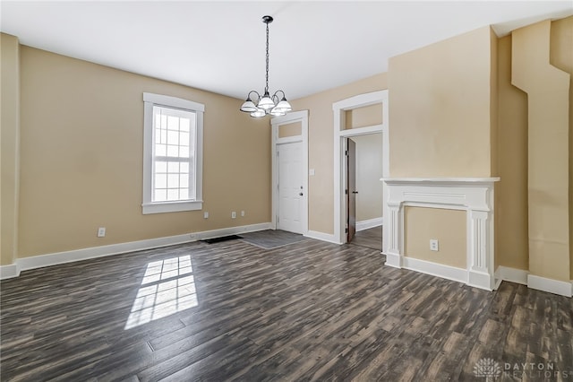 unfurnished dining area featuring an inviting chandelier and dark hardwood / wood-style floors