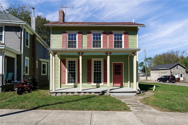 view of front facade with a front lawn and covered porch