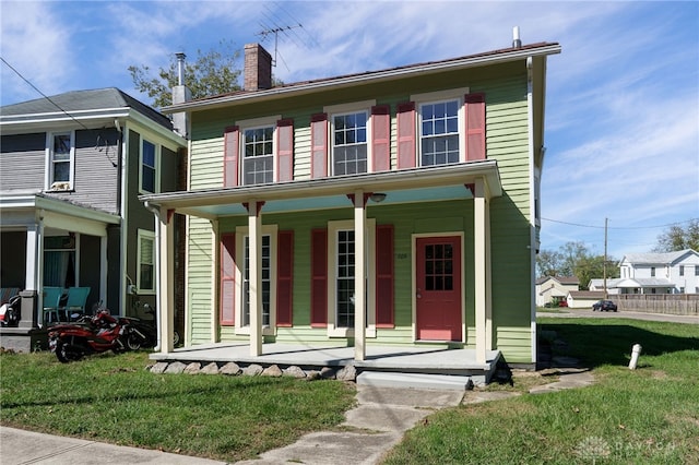 view of front of home featuring covered porch and a front lawn