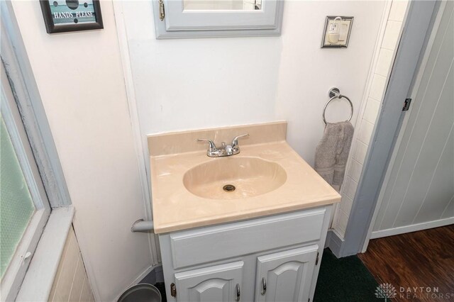 bathroom with hardwood / wood-style floors and vanity