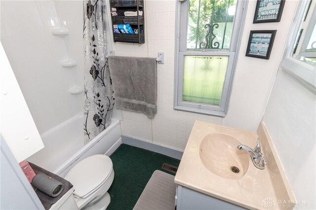 full bathroom with shower / tub combo, toilet, and vanity