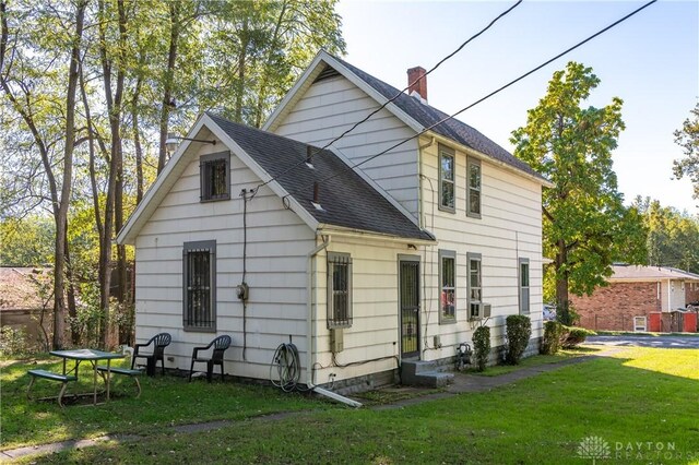 back of property featuring a yard