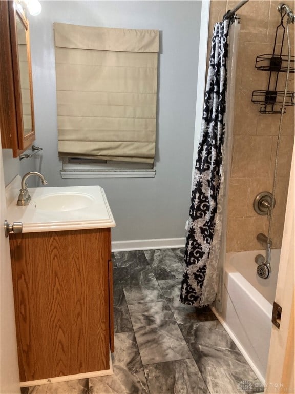 bathroom featuring shower / bath combo and vanity