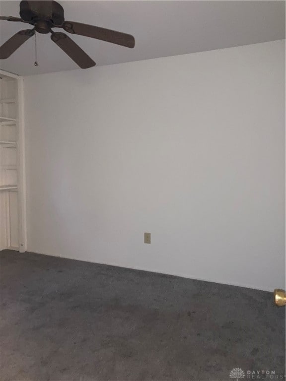 carpeted empty room featuring ceiling fan