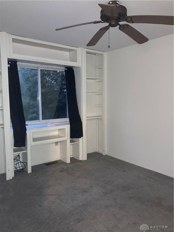 carpeted empty room featuring ceiling fan