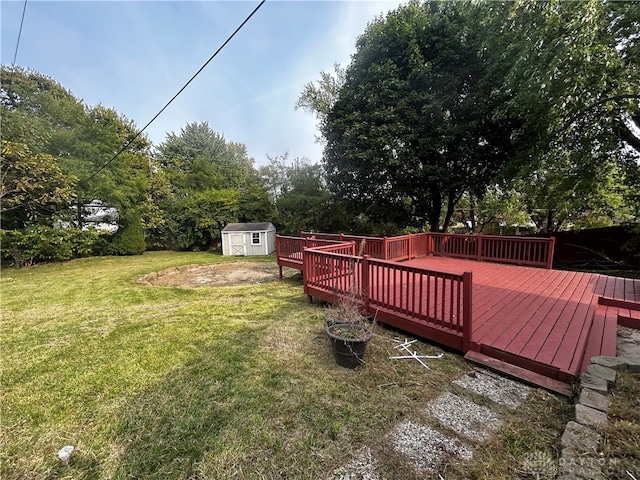 view of yard with a deck and a storage unit