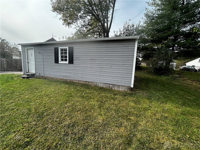 view of side of home featuring a lawn