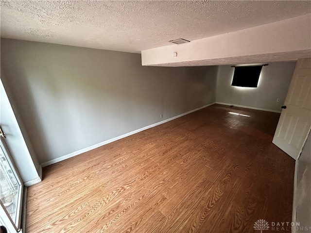 interior space with hardwood / wood-style flooring and a textured ceiling