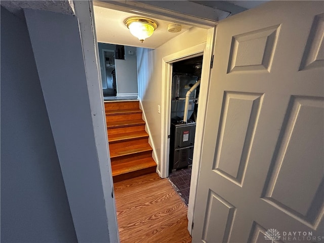 stairs featuring hardwood / wood-style floors