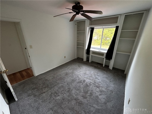 unfurnished bedroom featuring ceiling fan, a closet, and dark carpet