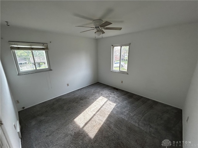 carpeted empty room featuring ceiling fan