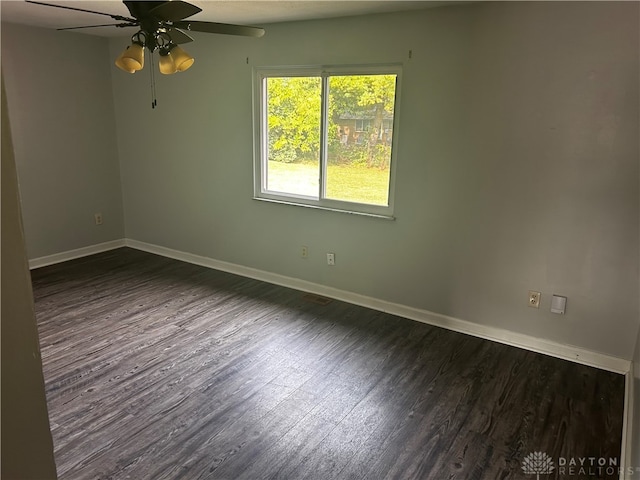 spare room featuring dark hardwood / wood-style floors and ceiling fan