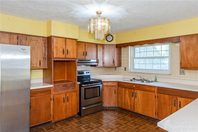 kitchen featuring stainless steel appliances, dark parquet floors, sink, decorative light fixtures, and backsplash