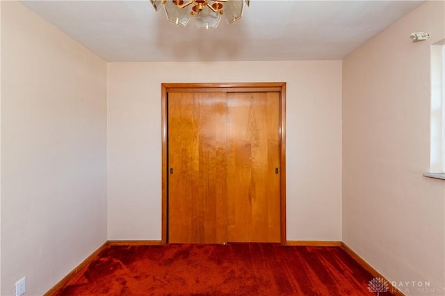 unfurnished bedroom with dark carpet